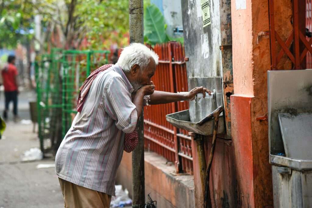 old man sipping safe borehole water