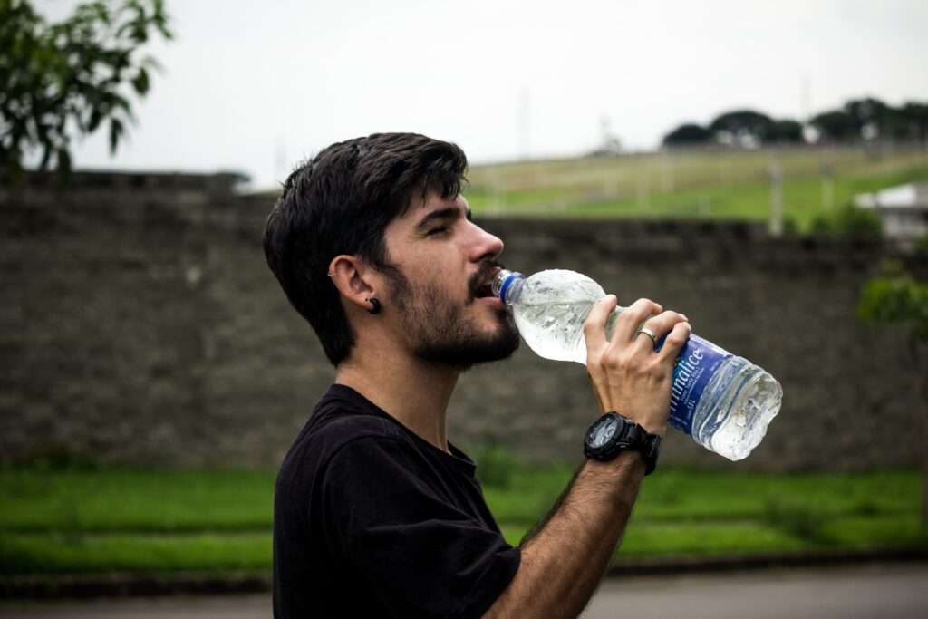 man drinking borehole water