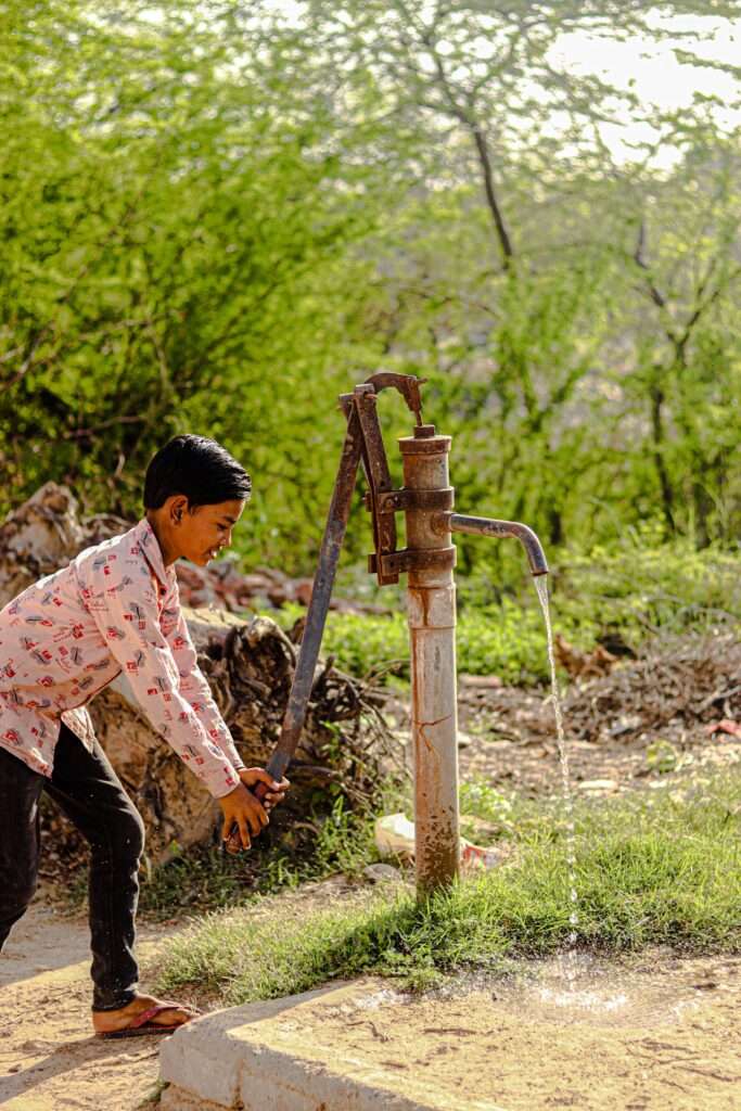 boy pumping water