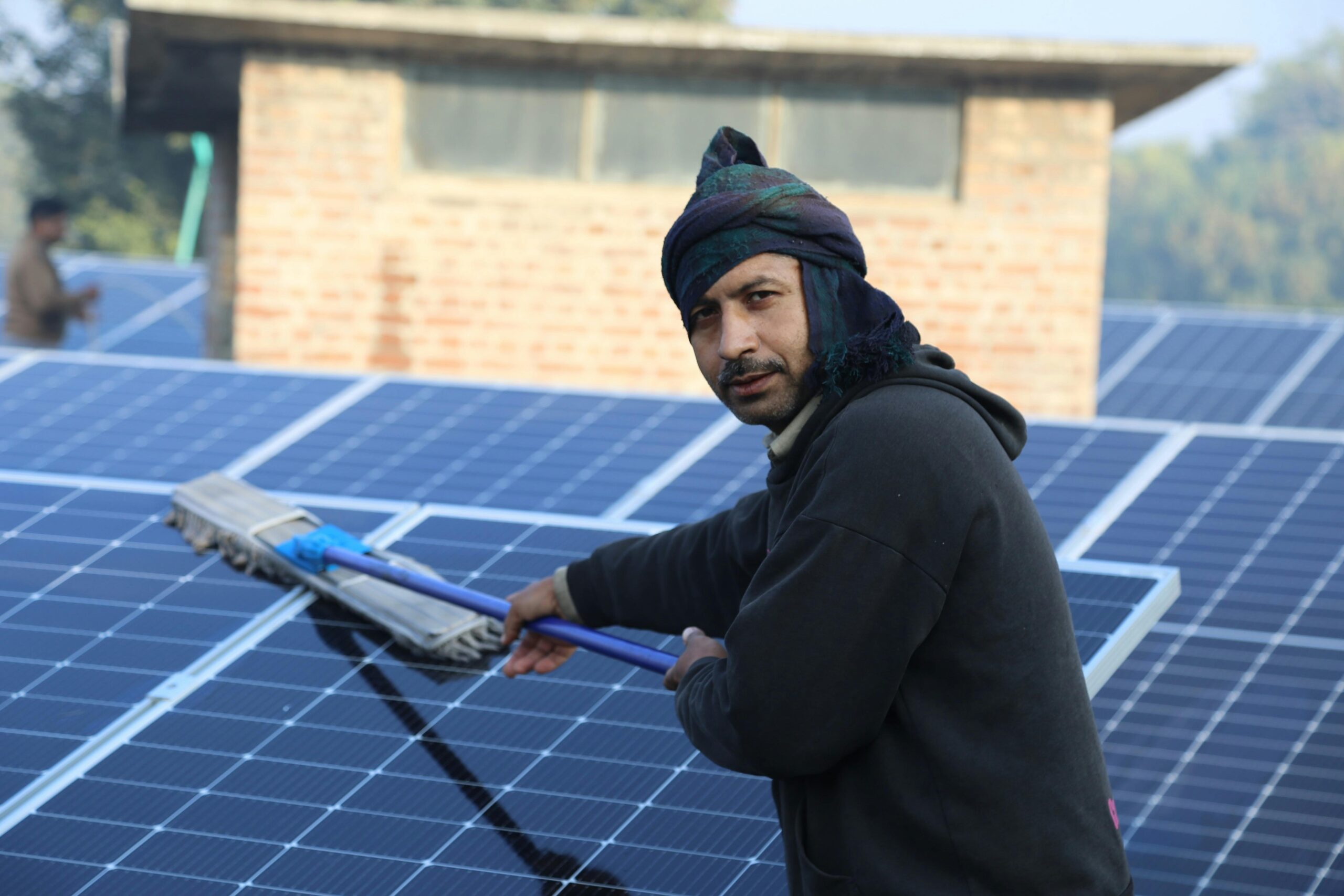 man cleaning solar panels