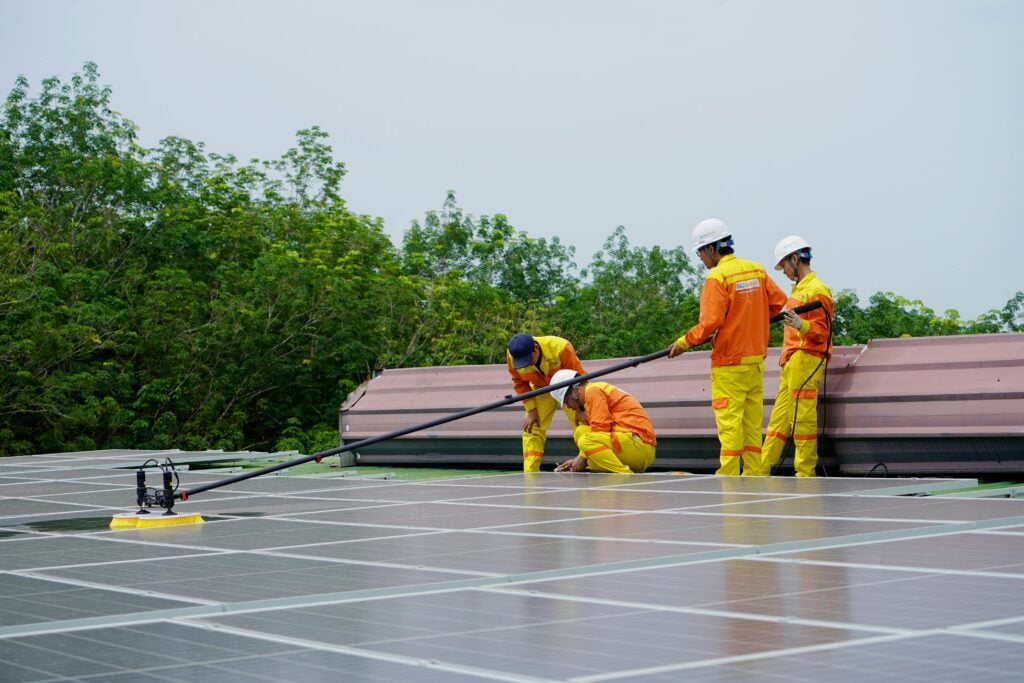 men cleaning solar panels