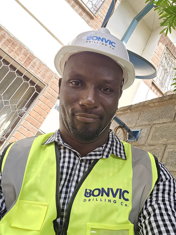 Ateya, Project Manager at Bonvic Drilling Co., on site in Bonvic-branded hard hat and safety vest